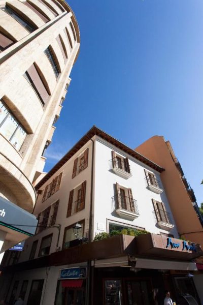 Fachada exterior del Hotel Bosch Boutique con balcones y persianas de madera en el centro de la ciudad