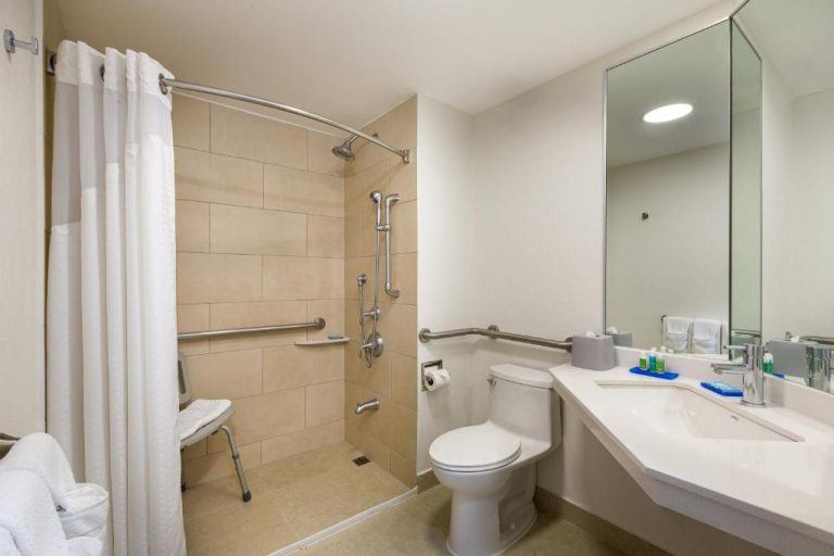 Baño adaptado con ducha accesible y barras de apoyo en Holiday Inn Express San José Costa Rica Airport