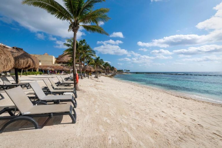 Playa privada con hamacas y palmeras del Catalonia Riviera Maya Resort & Spa All Inclusive en México