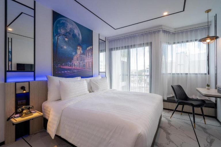 Habitación doble moderna con cama king y decoración nocturna en Ratri Hotel Phuket Old Town