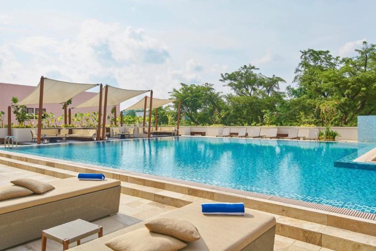 Piscina exterior con tumbonas y pérgolas del Orchard Rendezvous Hotel by Far East Hospitality en Singapur