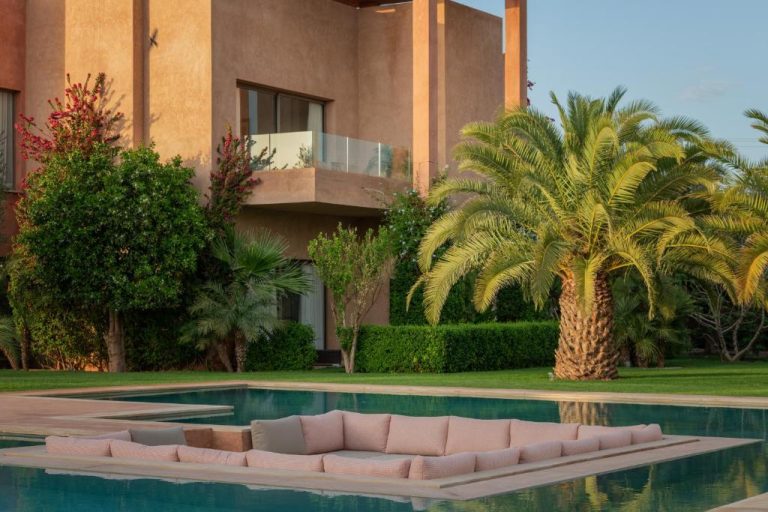 Piscina exterior con sofás y jardín tropical del Maison Kenoosha Boutique Hotel & Spa en Marrakech