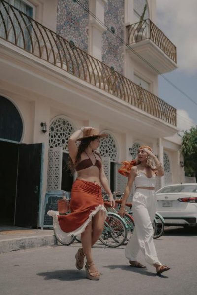 Dos mujeres paseando frente a la fachada del hotel Layla Tulum Adults Only con estilo bohemio