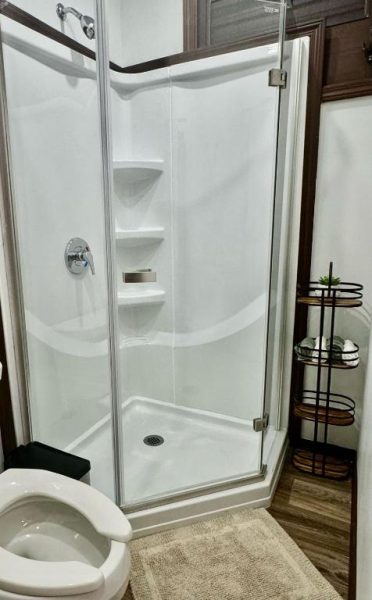 Baño con ducha independiente de cristal y estantes en Hacienda del Sur
