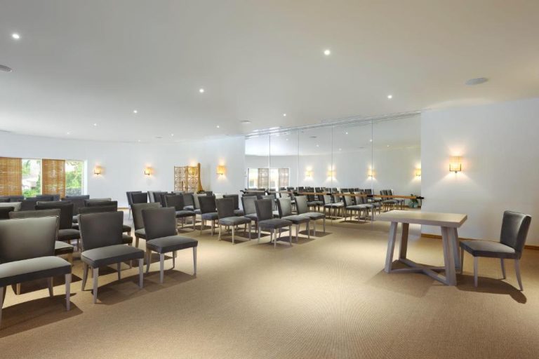 Sala de reuniones con sillas grises y espejos en Vilalara Grand Hotel Algarve