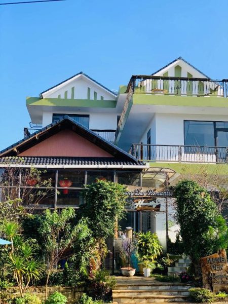 Fachada exterior del hotel Mang Den Romantic con jardín tropical y balcones en Vietnam