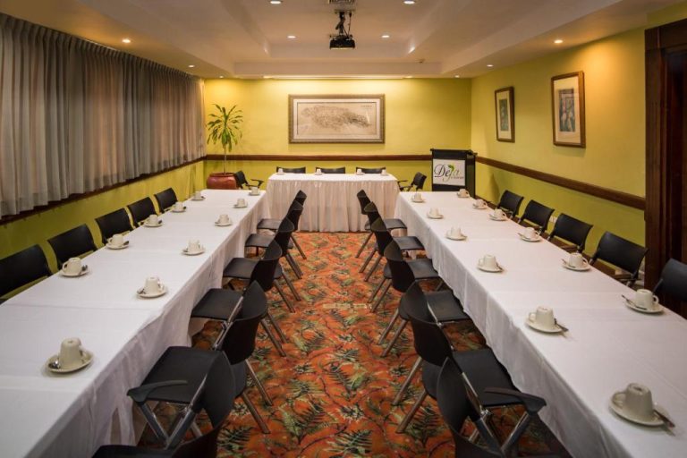 Sala de reuniones con mesas en U y proyector del Deja Resort All Inclusive