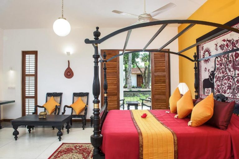Habitación con cama de dosel negra y decoración colonial tradicional en The Notary's House