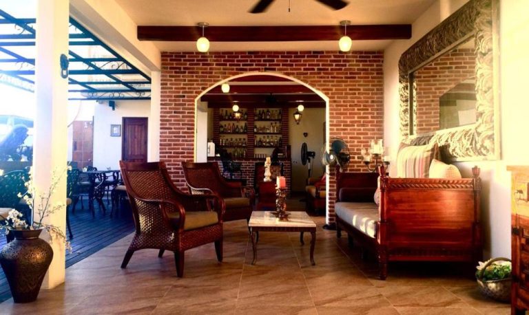 Lobby bar rústico con paredes de ladrillo y mobiliario colonial en La Pasion Colonial Hotel Boutique By Bunik