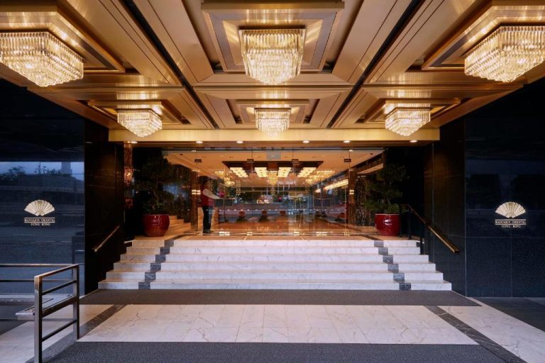 Entrada principal con escaleras de mármol y lujosas arañas de cristal del Mandarin Oriental Hong Kong