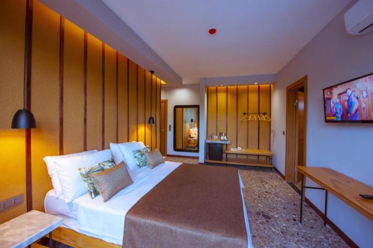 Habitación doble con cama king size y decoración moderna en madera del Arwen Hotel