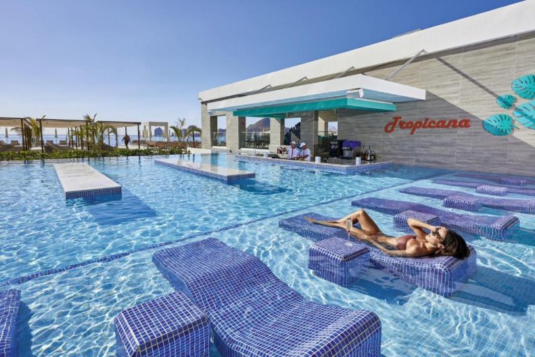Piscina infinity con tumbonas sumergidas y bar Tropicana en Riu Palace Baja California Adults Only