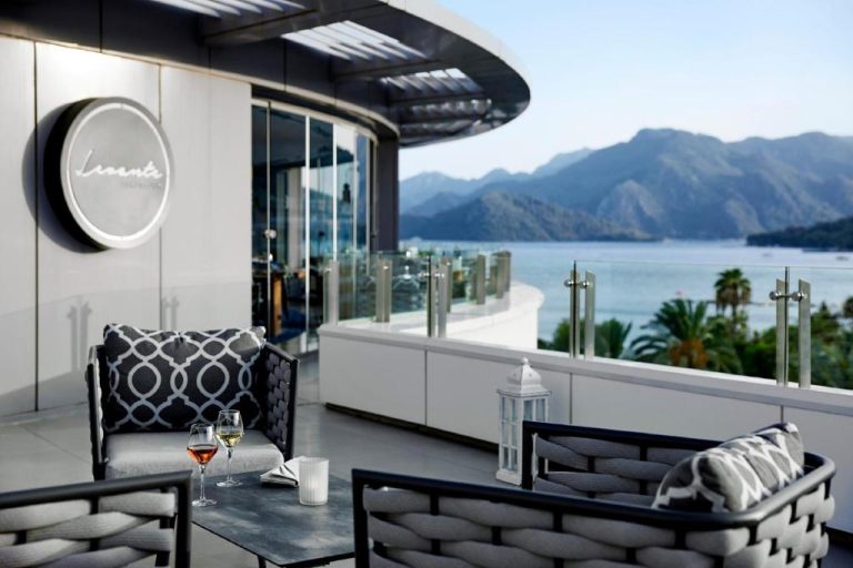 Terraza lounge del TUI BLUE Grand Azur con copas de vino y vistas al mar y montañas de Marmaris