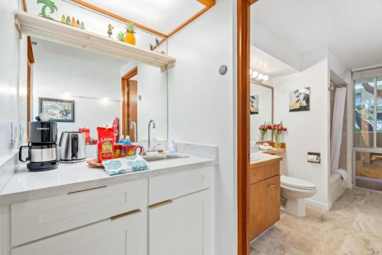 Cocina con cafetera y productos locales junto al baño completo en Marbella Lane Coastal Retreat cerca de Diamond Head