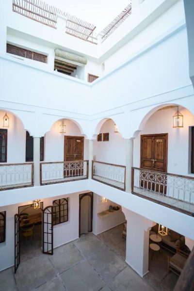 Patio interior con arcos blancos y balcones del Riad Rahal en Marrakech