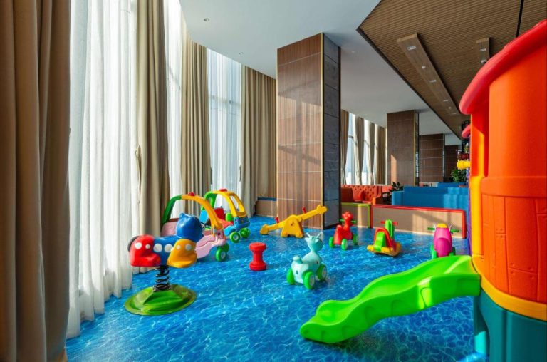 Zona de juegos infantil con toboganes y juguetes de colores en G8 Luxury Hotel Da Nang