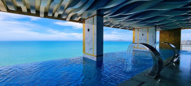 Piscina infinita con cascada y vistas al mar en Copacabana Jomtien Pattaya Seaview Skypool