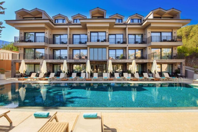 Piscina exterior con tumbonas y sombrillas del hotel adultos Casa Lumar Luxury Lodging en Turquía
