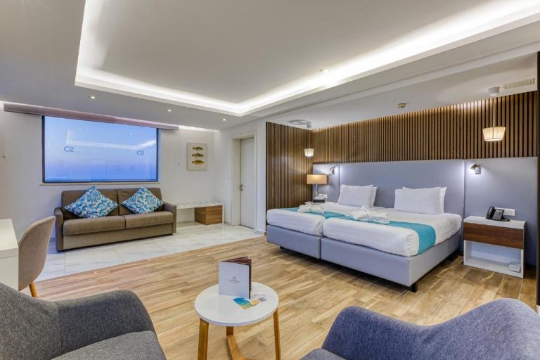 Suite deluxe con camas dobles y zona de estar del Solana Hotel & Spa en Malta