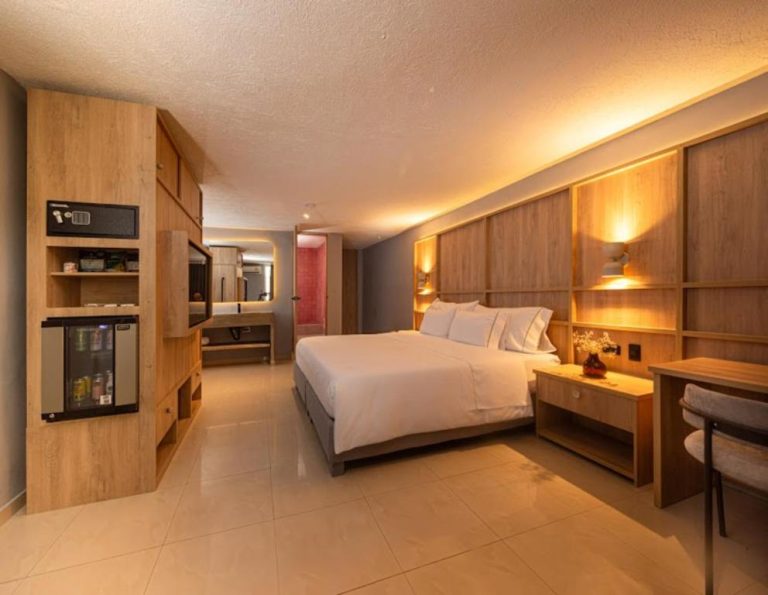 Habitación king deluxe con iluminación cálida y minibar en Mood Matuna Hotel Cartagena