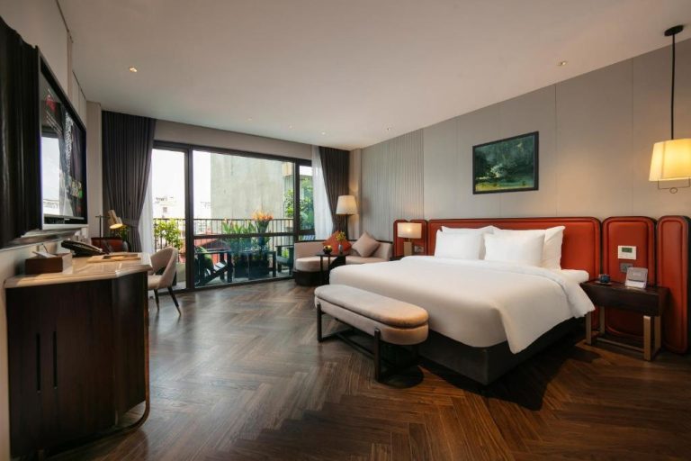 Habitación deluxe con cama king size y balcón exterior en Le Premier Hotel & Rooftop Bar