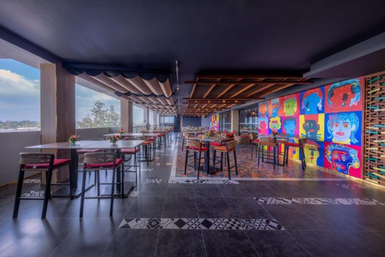 Restaurante con terraza y mural de arte pop colorido en Glee Nairobi Preferred LVX Hotel