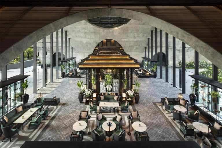 Impresionante lobby del Sindhorn Kempinski Hotel Bangkok con arcos de concreto y lujosa decoración interior