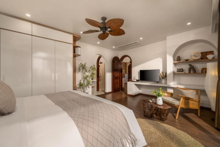 Habitación suite con ventilador de techo tropical y decoración natural en Saha Casa Boutique Hotel Da Nang