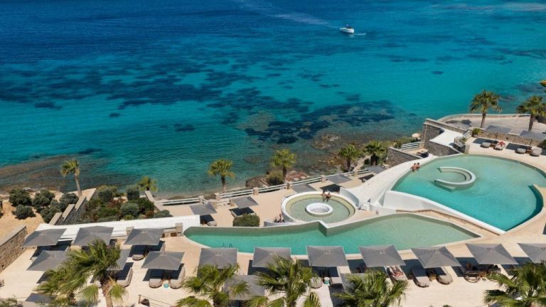 Piscina infinita con tumbonas y vistas al mar turquesa del Anax Resort and Spa en Mykonos