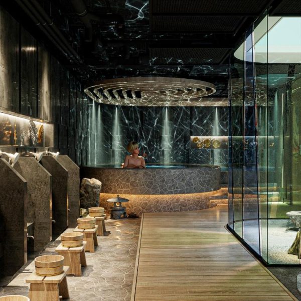 Lujosa zona de spa onsen japonés con bañera de piedra y cascada de agua en Hotel du Lac Signature