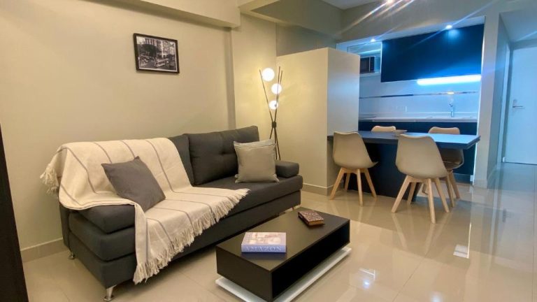 Salón comedor moderno con sofá y cocina integrada en Centro Histórico Apart I