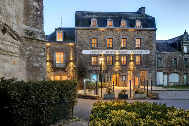 Fachada exterior iluminada del Hotel Restaurant Lesage, edificio de piedra bretona con encanto histórico en Francia
