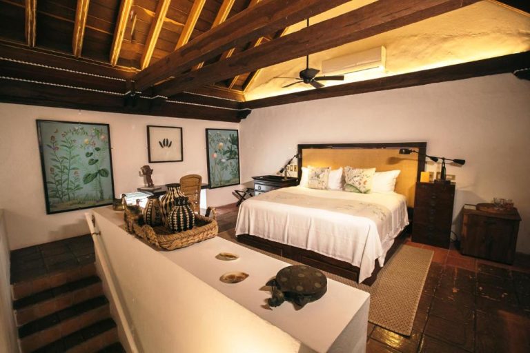 Habitación colonial con vigas de madera y cama doble en Amarla Boutique Hotel Cartagena
