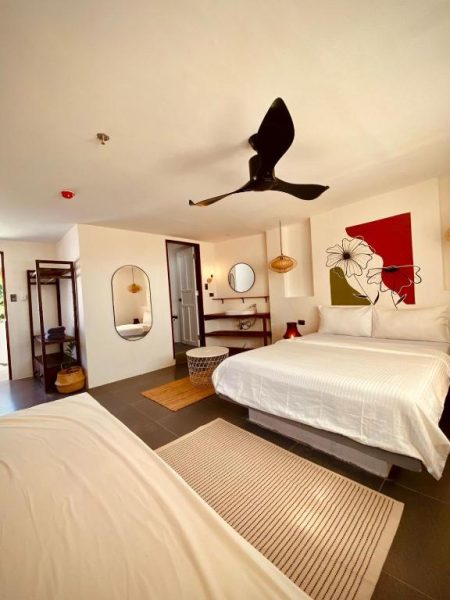 Habitación doble con dos camas y ventilador de techo en Happiness Hostel Boracay
