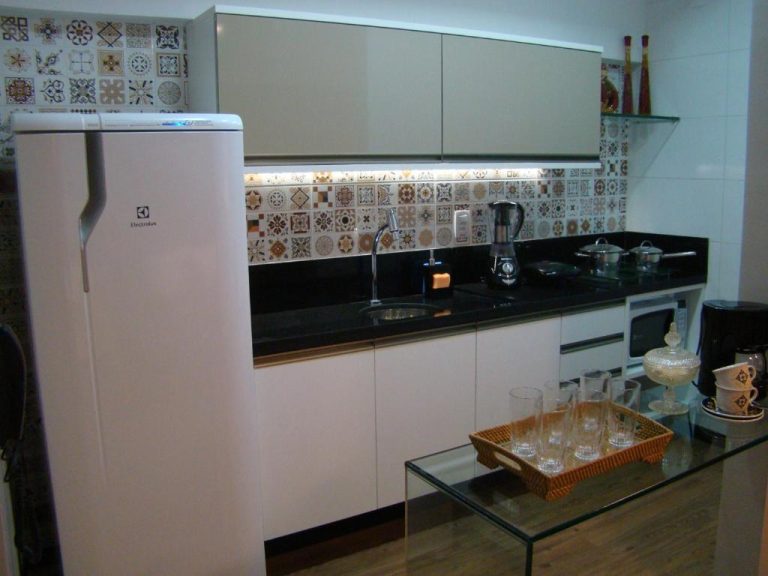 Cocina totalmente equipada con nevera Electrolux y encimera negra en el Flat 508 Recife