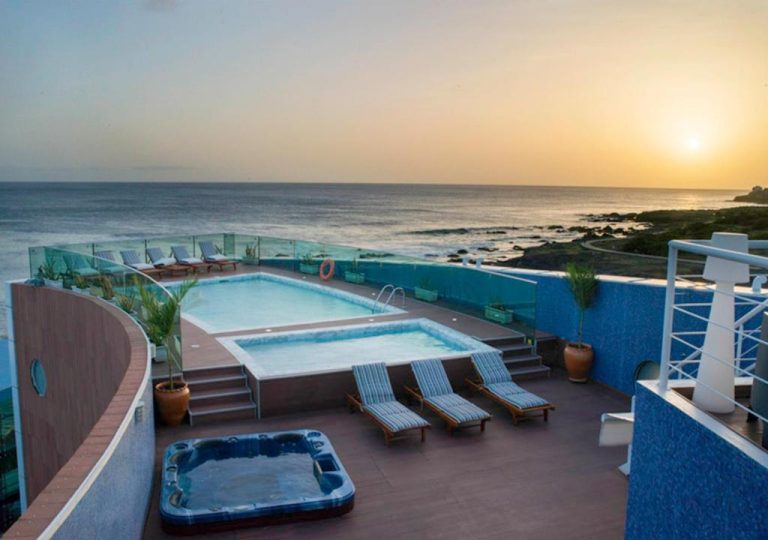 Piscina en azotea con jacuzzi y tumbonas del Hotel Vip Praia con vistas al atardecer sobre el océano