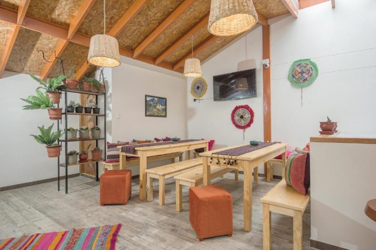 Salón comedor rústico con mesas de madera y decoración andina en Casa Matara Boutique