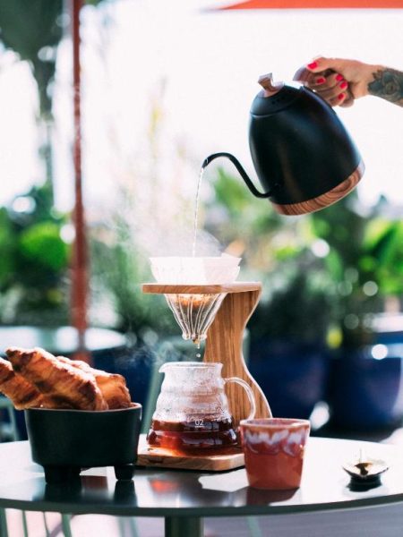 Preparación de café pour over artesanal con croissants en la terraza del Three House Hotel