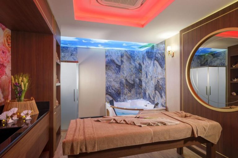 Sala de masajes y spa con jacuzzi y camilla del hotel Elysium Green Suites