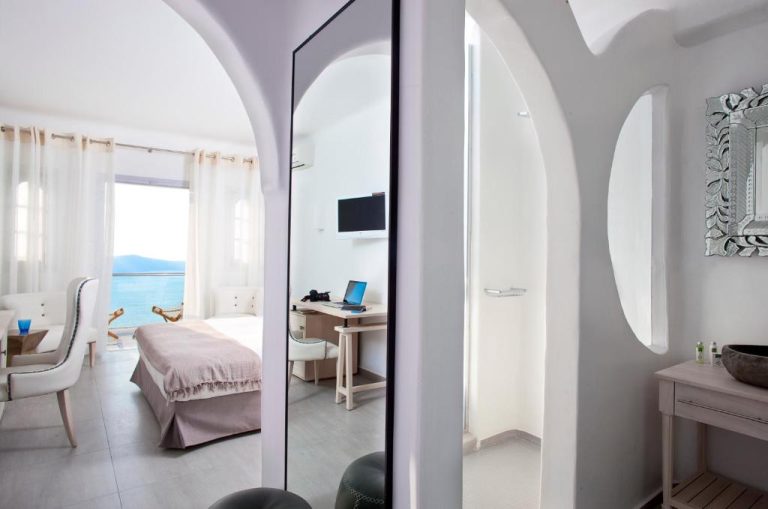 Habitación con arcos blancos y vista al mar en Belvedere Suites, decoración estilo cicládico