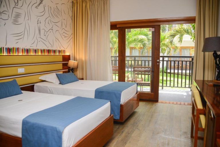 Habitación doble con dos camas y balcón con vistas al jardín tropical en Hotel Odjo d'água