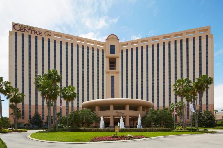Fachada exterior del Rosen Centre Hotel Orlando con fuentes ornamentales y palmeras tropicales
