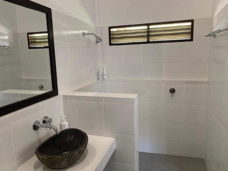 Baño moderno con lavabo de piedra natural y ducha abierta en Balong Balong Surf Bungalows