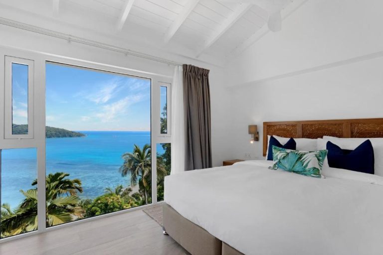 Habitación doble con cama king y vistas al mar turquesa en The Bay Seychelles Boutique Hotel