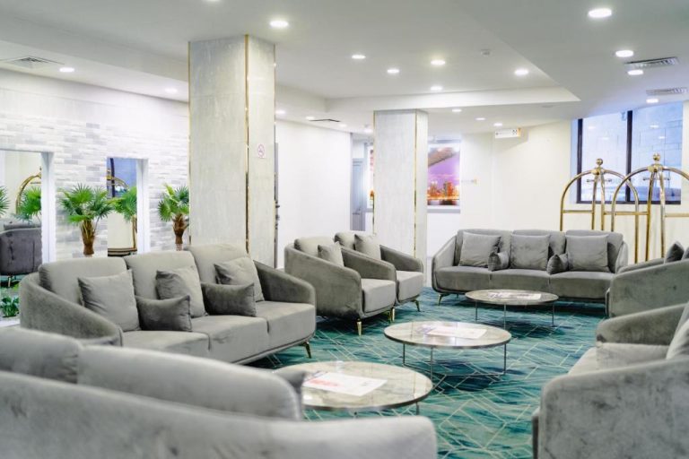 Amplio lobby con sofás grises y mesas de centro del Manhattan Business Hotel en Male, Maldivas