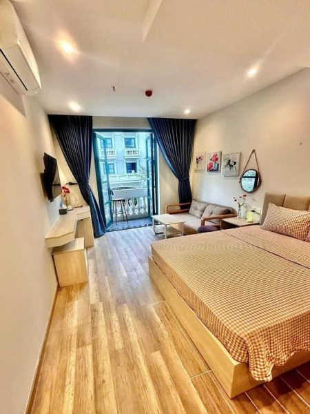 Habitación doble con suelo de madera y balcón exterior en Minh Anh Hotel Vietnam