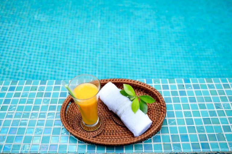 Servicio de zumo tropical y toalla junto a la piscina del Hoi An Majestic Villa