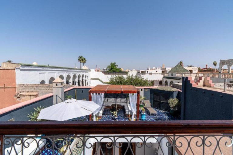 Terraza con pérgola y sombrilla del Riad Serendip con vistas a los tejados de Marrakech