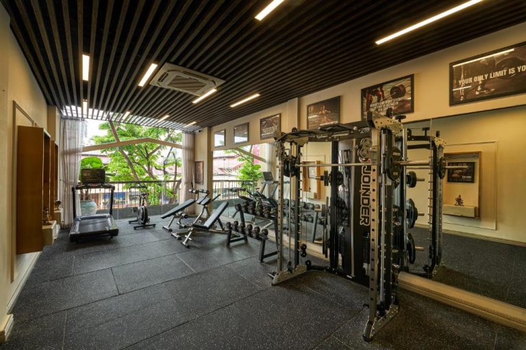 Gimnasio moderno con máquinas Joinder y mancuernas en Grand Hotel du Lac Boutique Saigon