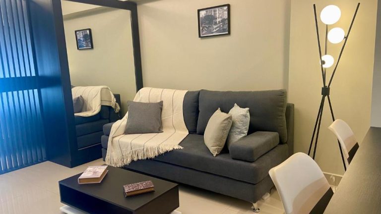 Salón moderno con sofá gris y mesa de centro en apartamento Centro Histórico Apart I